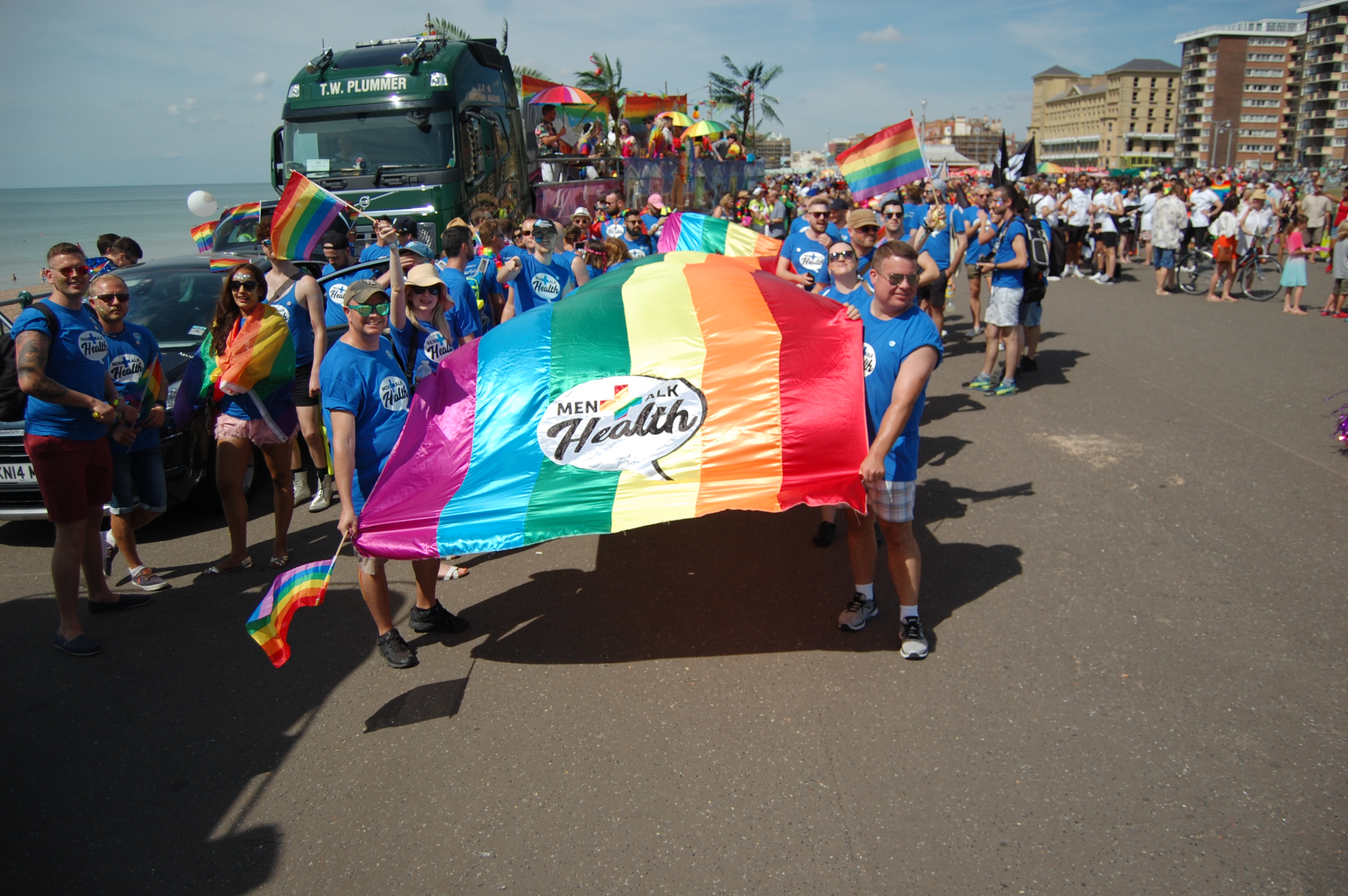Northstar IT team supporting MenTalkHealth UK charity at Brighton Pride 2019, carrying a rainbow flag.
